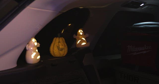 Inside a car with lit Halloween decorations
