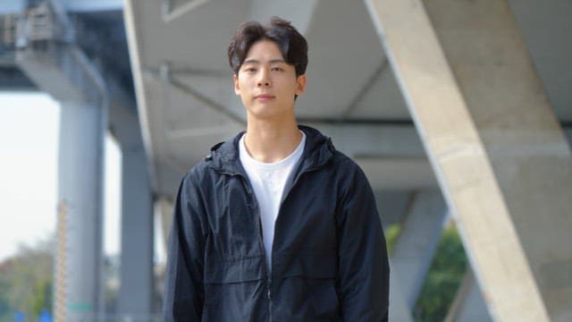 Young man standing confidently outdoors