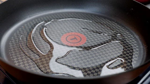 Pancake batter placed on an oiled frying pan