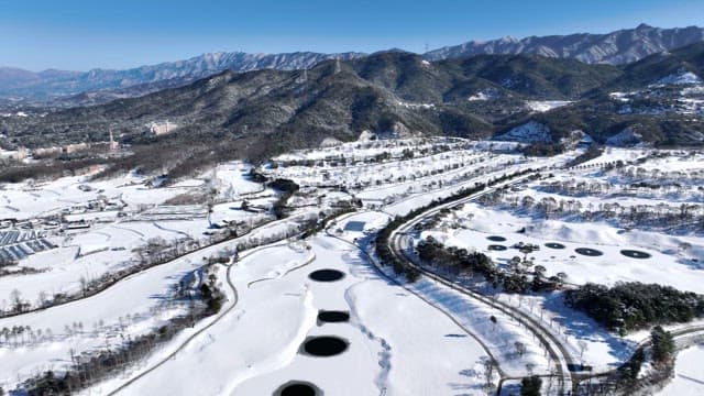 Snow-Covered Rural Landscape with Mountains