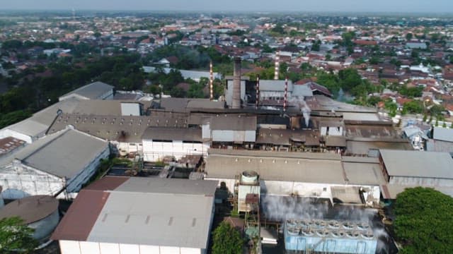Industrial complex in the city with smoking chimneys