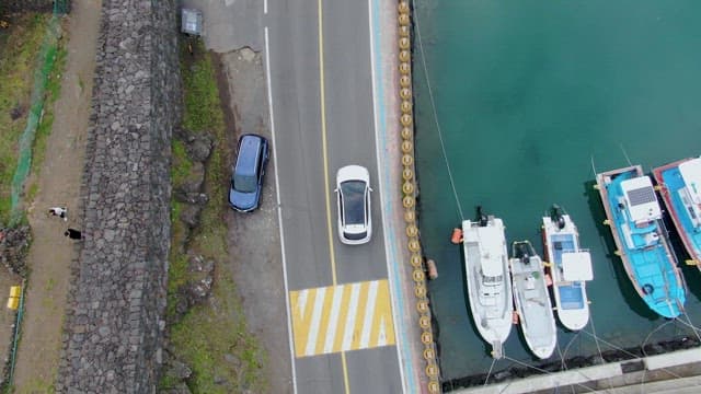 Cars driving along a coastal road