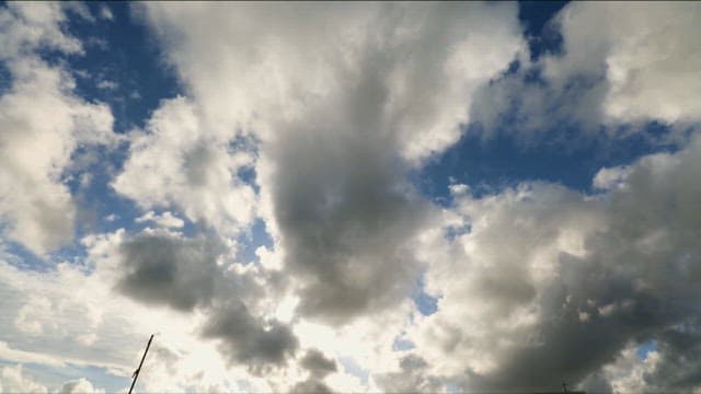 Dark clouds across the blue sky