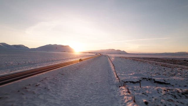 Snowy landscape with a road at sunrise
