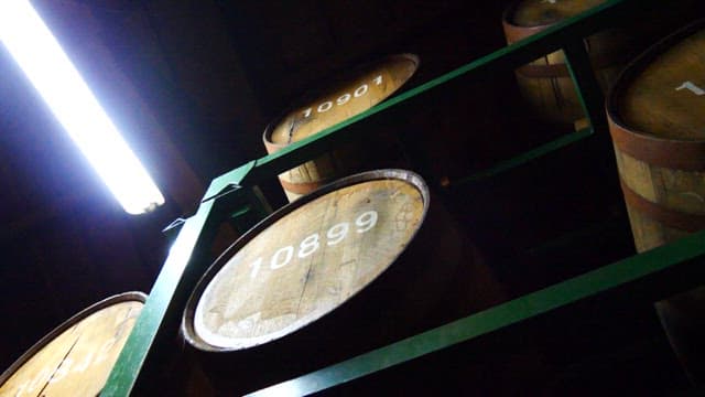 Barrels stored in a dimly lit brewing warehouse