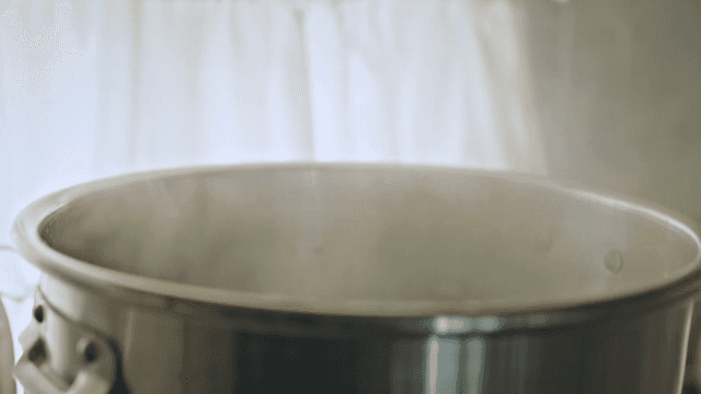 Homely kitchen scene with boiling pot