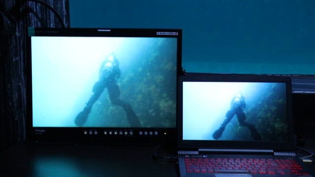 Scuba diver exploring underwater, displayed on monitors