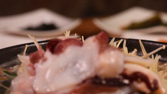 Bean sprout and rice soup with octopus served in a hot stone pot