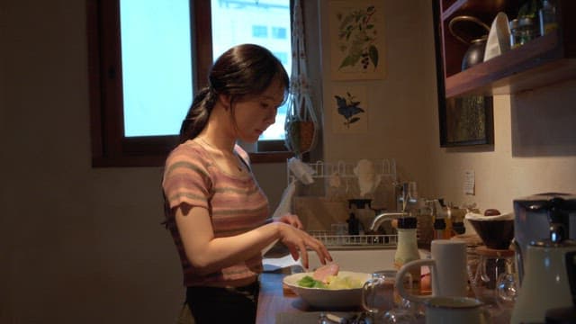 Woman preparing a salad in the kitchen