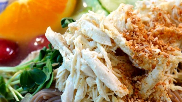 Close-up view of delicious noodles topped with chicken gravy