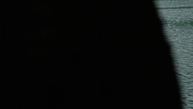 Small wooden hut floating on a calm lake