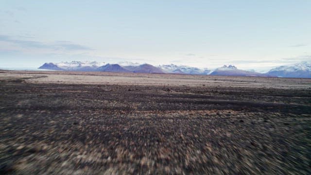 Vast landscape with distant snowy mountains