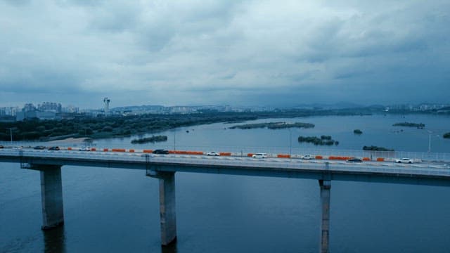 Bridge over a river with city skyline