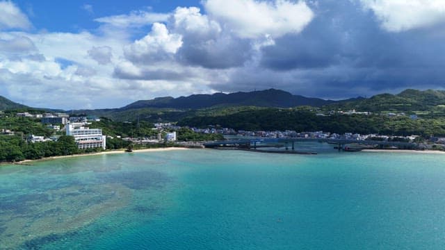 Coastal city with mountains and clear sea