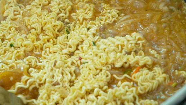 Ramen noodles boiling in a pot
