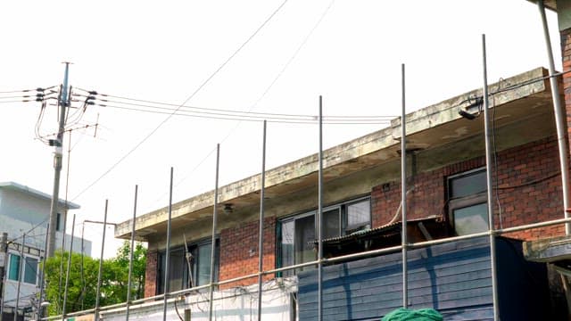 Old brick building with a construction fence
