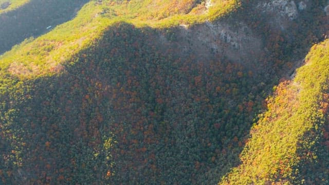 Rural village with mountain ranges and vast farmlands during daytime