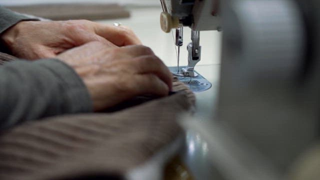 Elderly Person Sewing on a Machine