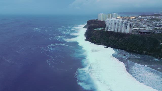 Coastal city with waves crashing
