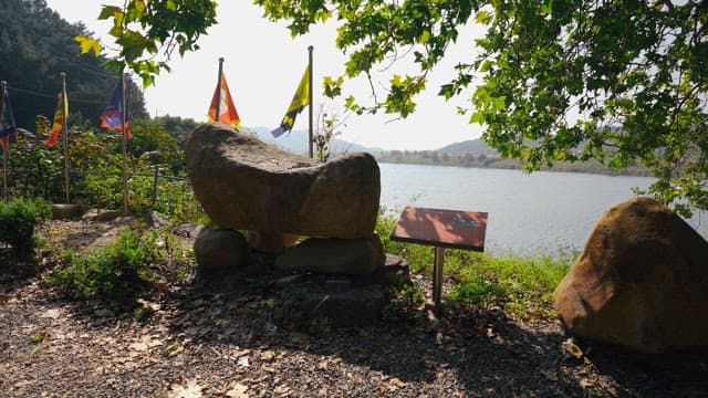 Rock tower surrounded by trees and greenery