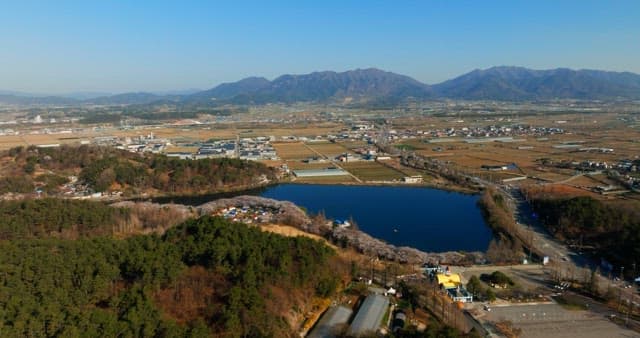 View of large pond with surrounding town