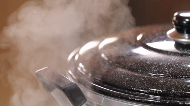 Steam rising from a steamer in which food is being cooked