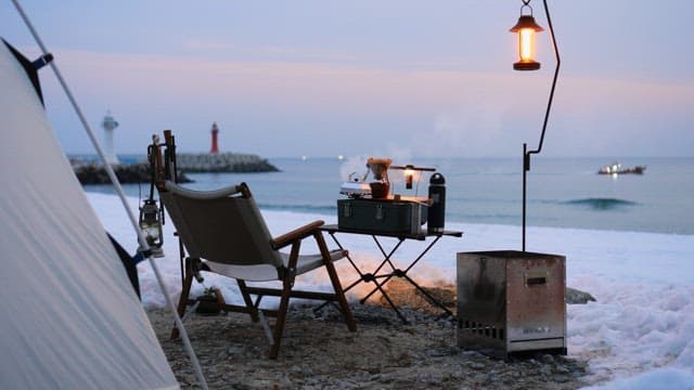 Camping gear set up on a snowy beach