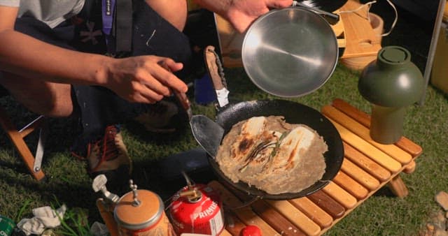 Preparing Vegetable Pancakes Outdoors at Night during Camping