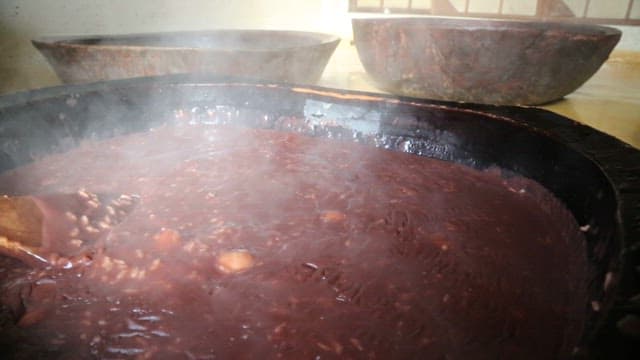 Making Red Bean Porridge with Glutinous Rice in a Traditional Cauldron