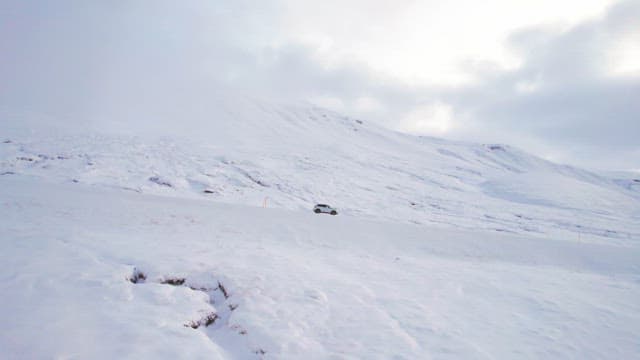 Car driving through a snowy landscape