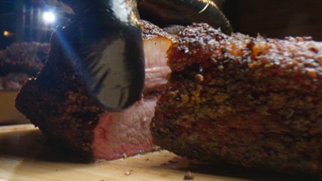 Cutting Juicy Roast Barbecue on a Cutting Board