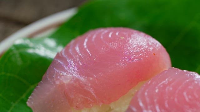 Fresh tuna sushi on a green leaf
