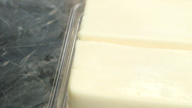 Blocks of cheese in a plastic container