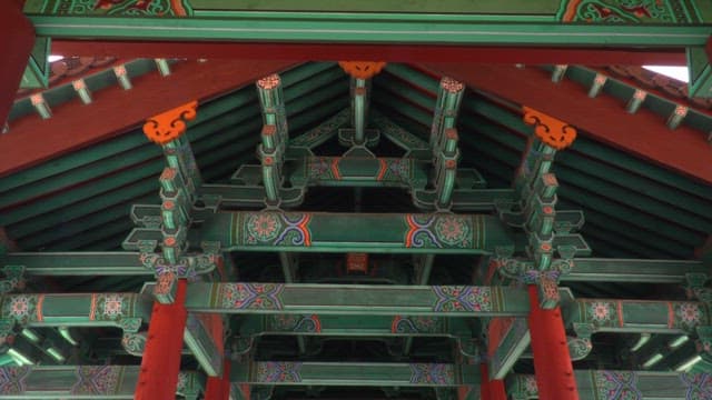 Ornate interior of a traditional Korean building with tourists