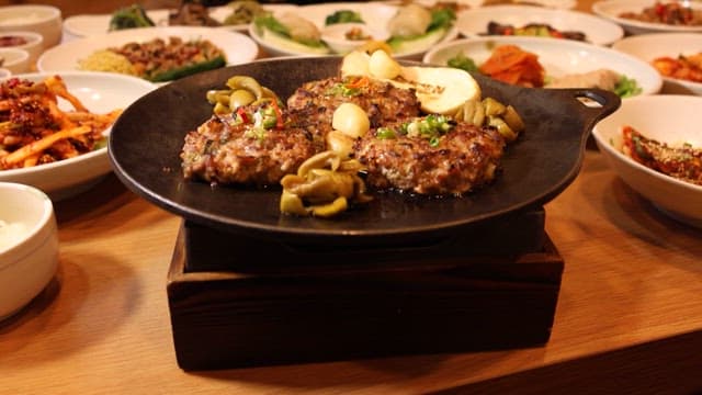 Juicy Grilled Patties Served with Various Side Dishes