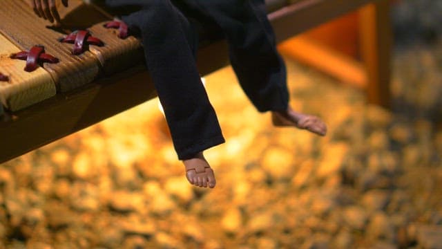 Hands dressing a small model figure