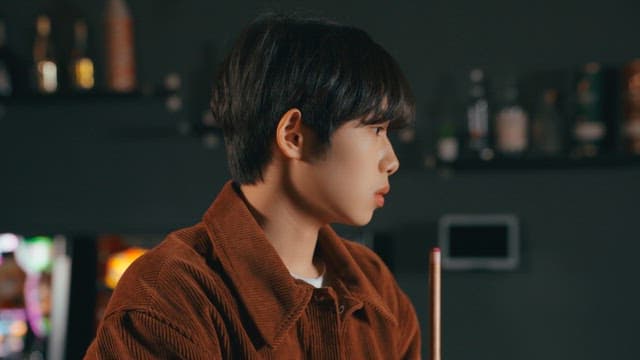 Young man focused on playing pool indoors