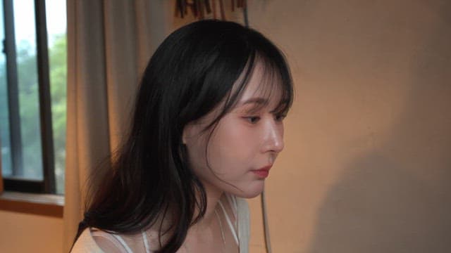 Woman applying skincare indoors