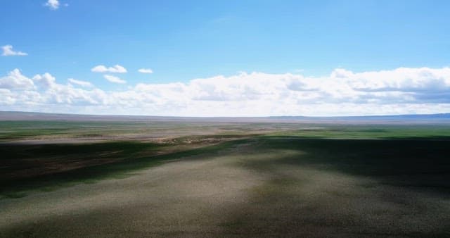 Vast open landscape under a blue sky