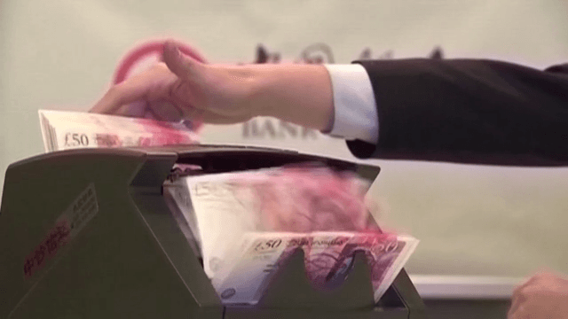 British Pound Currency Being Counted on a Counting Machine of Bank