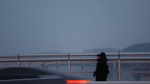 Person walking on Yanghwa bridge at evening