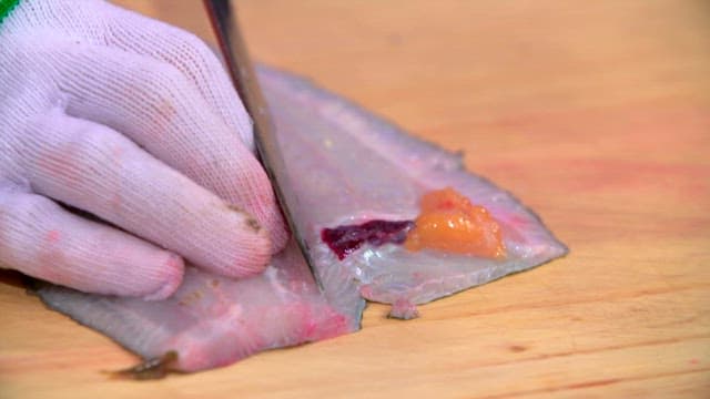 Filleting flatfish on a wooden cutting board
