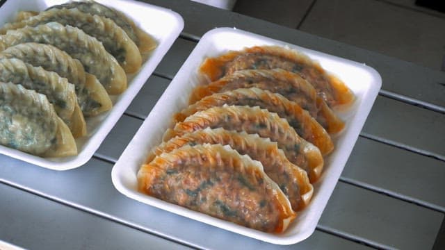 Kimchi dumplings, meat dumplings, and steamed buns prepared on the table in the store
