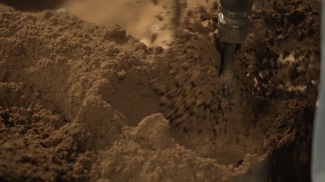 Scene of soil being compacted with a machine