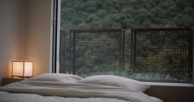 Serene Bedroom Overlooking Dense Forest