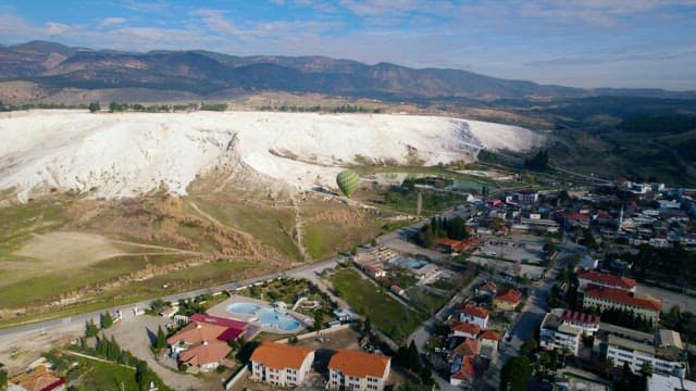Hot Air Balloon On a Hill with White Limestone Roofs