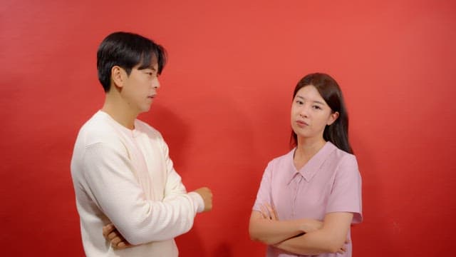 Man and a woman pointing fingers at each other and criticizing each other