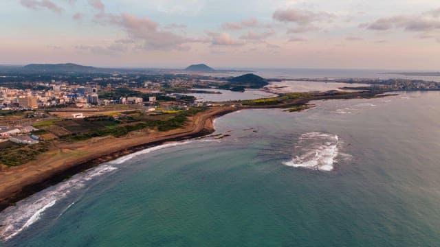 Coastal cityscape with distant mountains