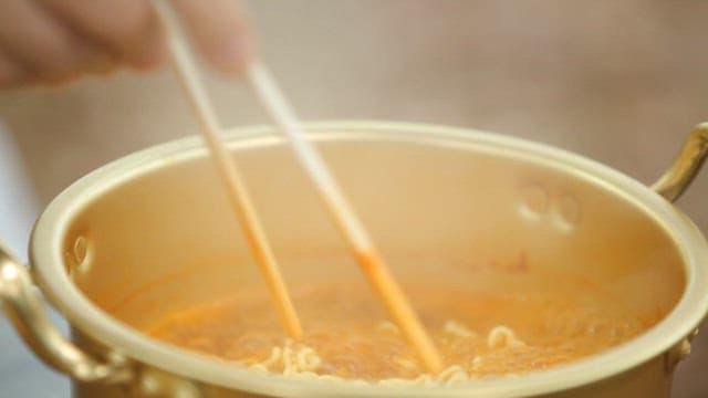 Chopstickful of warm ramen from a pot of sheep
