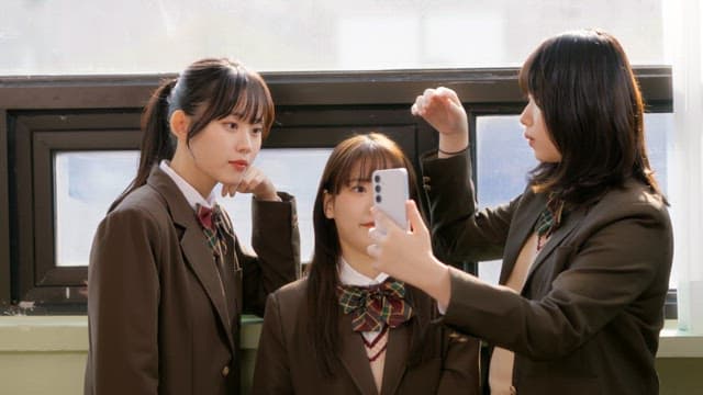 Students taking selfies in school